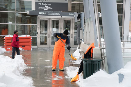 Clearing snow from a bus stop