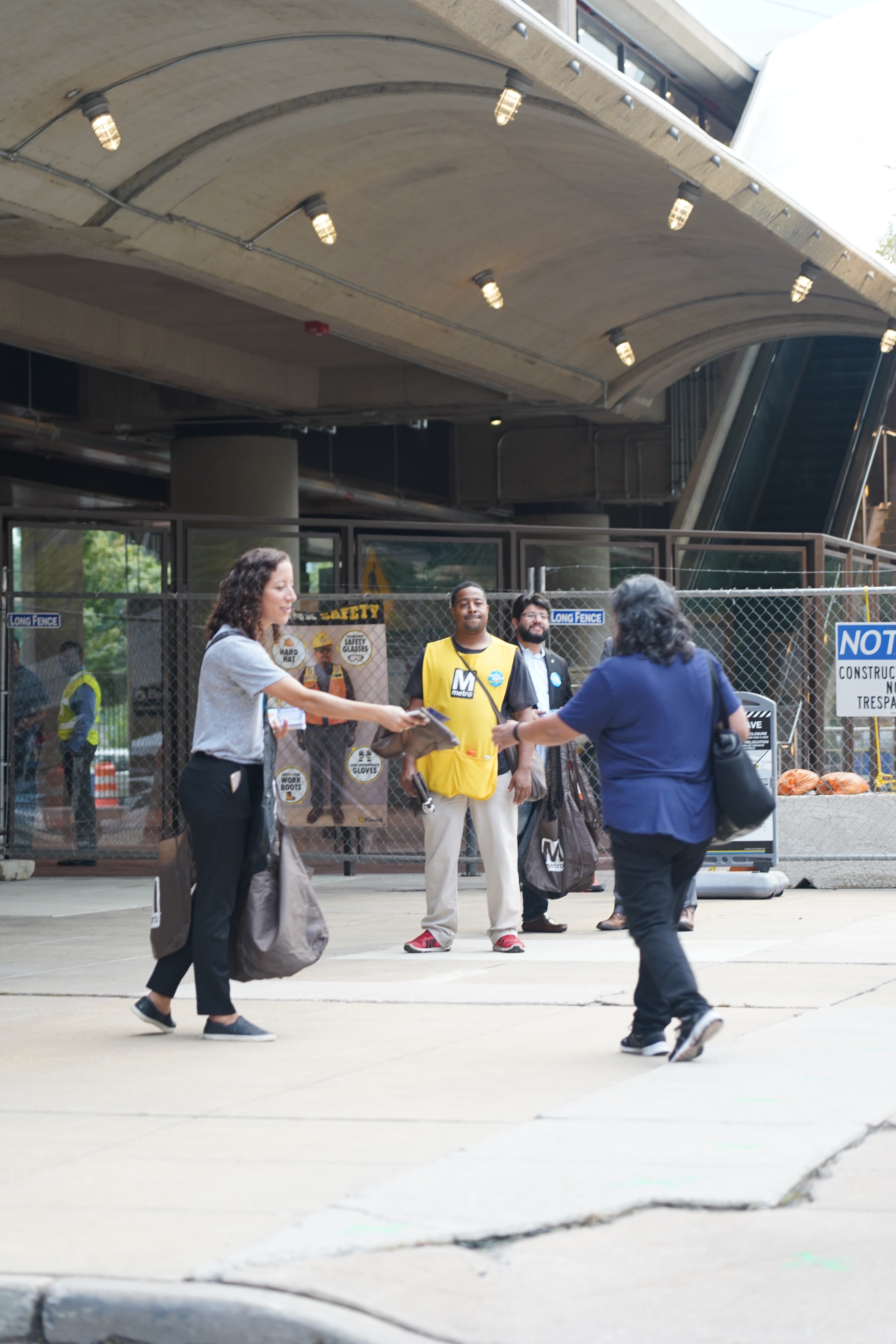 Metro staff greet riders at station entrances