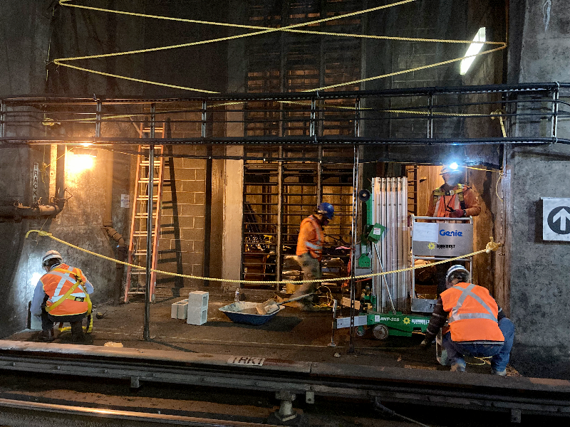 To maximize work production and safety, Metro used a new plan separating the work zone in the tunnel. Here, workers are installing a rope and mesh barrier system. The barrier system allows work to continue 24/7 avoiding disruption to train service.