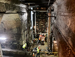 Aerial view of a ventilation shaft passage between the inbound and outbound tunnels. Here crews are preparing to install several vertical columns that will support the second floor and bridge across the tracks.