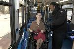 A Metrobus operator assists a customer in a wheelchair.