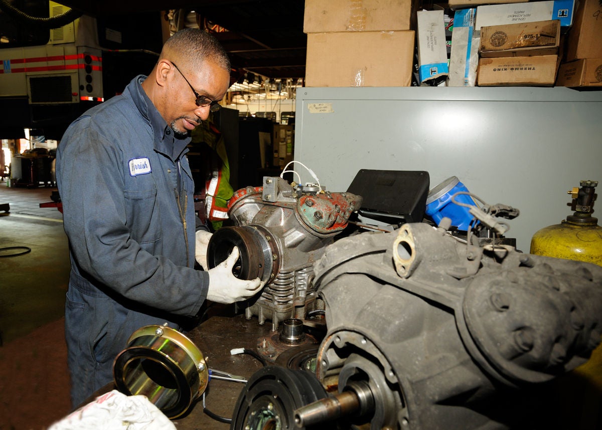 Landover Bus Division Mechanic Working on an engine