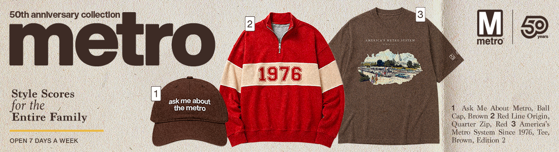 Metro's 50th anniversary pop up shop. Image has a brown ball cap with 'ask me about metro' stitched on the front. a red quarter zip, and a brown shirt that say's 'America's Metro'