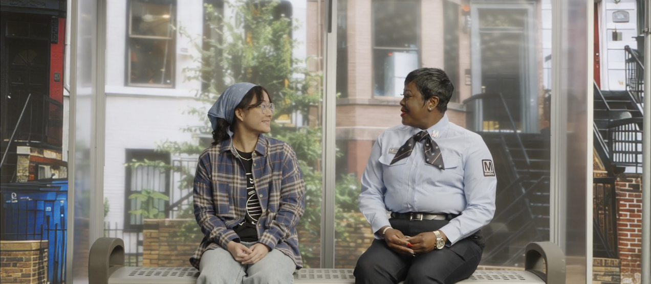 Claire sitting down with bus driver