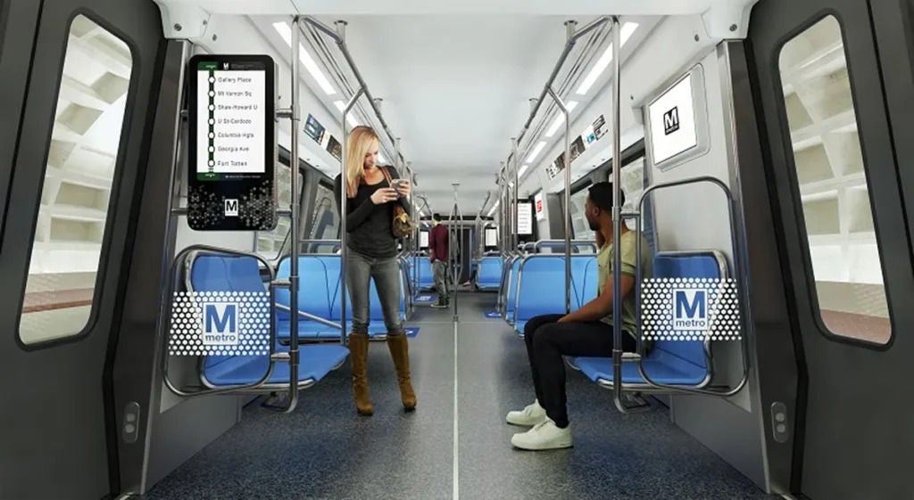 two people inside an 8000 series train