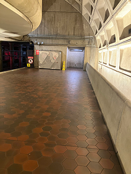 A picture of the elevator alcove on the Greenbelt side of the platform. The tracks are on the left of the picture and the station wall is on the right. The elevator is in the right corner in the background.